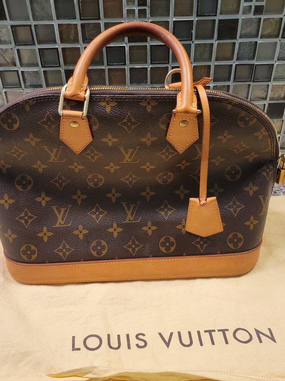 Louis Vuitton Monogram Alma PM Leather Satchel in Brown
